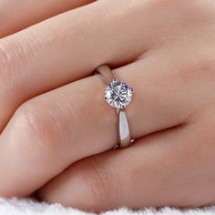 Simple and stunning, this ring showcases a magnificent round cut solitaire standing tall in the traditional four-prong setting. With its classic design and sparkling stone, this ring is a beautiful complement to any attire. The stone in this engagement ring shine brightly enough to be deserving as a symbol of your love.Carat Weight: 1.9 ctStone Size: 6.5 mmStone Type: Jeulia® StoneNumber of Stones: 1 Stone Color: Diamond WhiteStone Shape: RoundWeight: 2.76 gWidth: 7.7 mmHeight: 6 mmThickness: 2.7 mmMaterial: 925 SilverPlating Color: Silver Elegant Solitaire Diamond Ring For Proposal, Elegant Diamond Ring With Tension Setting For Proposal, Round Solitaire Diamond Ring For Formal Events, Round Cut Single Diamond Proposal Jewelry, Classic Solitaire Diamond Ring For Proposal, Classic Solitaire Diamond Proposal Ring, Solitaire Diamond Promise Ring With Round Stone, Single Diamond Round Cut Ring For Proposal, Classic Solitaire Round Stone Ring