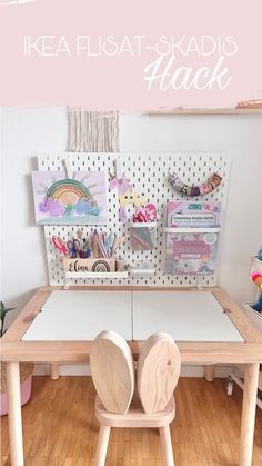 two wooden chairs sitting on top of a table next to a white board with pictures