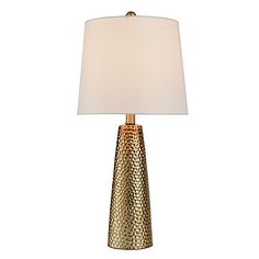 a gold table lamp with a white shade