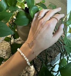 Hand chain Hand Chain is handcrafted in 14K gold-filled and embellished with dangling bezeled white CZ gemstones. L E T S . T A L K . H A N D . C H A I N ✤ Available in 14k Gold Filled or Sterling Silver ✤ Bezel CZ setting stone ✤ Bracelet Length (wrist): 6" with 1" extension at clasp to adjust size ✤ Ring size is crafted for one size fits all. ✤ Extremely delicate but very durable and comfortable. ✤ Tarnish resistant ✤ Safe for sensitive skin All purchased items will arrive in a Tommassini Jewelry box, If you purchase more than one item, I will place it all into one box, unless requested otherwise in a note. All Tommassini pieces are handmade by me, with love, in my Los Angeles based studio. All my designs are original and sometimes even a one of a kind if stated. After an order has been Gold Bohemian Dangle Bracelets, Gold Plated Dangle Chain Bracelet With Adjustable Chain, Finger Bracelets, Hand Chain Bracelet, Jewelry Chain, Hand Bracelet, Jewelry Lookbook, Hand Chain, Hand Jewelry