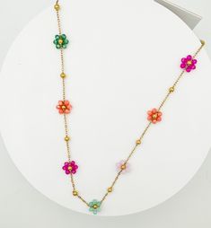 A vibrant charm necklace to brighten up your look! An arrangement of colorful beads intricately woven together to create a charming floral centerpiece.  DIMENSIONS Length: 15" Ext: 3' ball ext. Clasp: lobster claw Metal Finish: Gold Plated Product: Lead & Nickel Compliant Anti-tarnish: Double E-Coating FREE SHIPPING ON ALL ORDERS OVER $35 Multicolor Beaded Necklace With Flower Charm For Summer, Multicolor Round Beads Flower Necklace For Summer, Multicolor Flower Necklace For Summer Beach, Summer Flower Beaded Necklaces, Bohemian Multicolor Flower Necklace For Summer, Spring Multicolor Beaded Flower Necklace, Summer Beach Flower Necklace With Charm, Summer Beach Flower Necklace With Flower Charm, Summer Beach Flower Charm Necklace