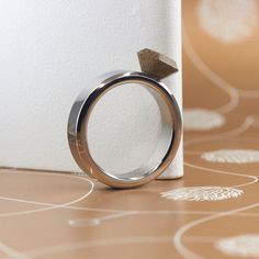 a ring with an arrow on it sitting next to a white piece of paper that has been placed on the ground