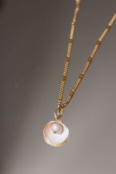 "A beautiful seashell form and a unique freshwater pearl. The brightness and shininess of the pearl makes this piece truly one of a kind!  This stunning necklace speaks to the uniqueness of each woman. With a bold, yet organic shape and a rich variety of real seashells, it will make you feel beautiful inside out. ♥ GIFT NOTE If you would like to include a short gift note during your order, we will be happy to add a short handwritten gift note to your order. Please let us know your message at che Pearl Drop Shell, Gift Pearl Drop Shell Made Of Mother Of Pearl, Mother Of Pearl Shell With Pearl Drop As Gift, Mother Of Pearl Shell Necklace As Gift, Mother Of Pearl Shell Necklace For Gift, Ocean-inspired Pearl Charm Jewelry As Gift, Ocean-inspired Pearl Charm Jewelry For Gifts, Ocean-inspired Pearl Charm Jewelry Gift, Pearl White Mother Of Pearl Shell Necklace As Gift