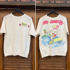 "Vintage 1960's \"Mr. Hawaii 69\" Airbrush Artwork Hanes Cotton Shirt Sleeve Sweatshirt. Tag Size L. Please check the measurements below.  Very good condition. The label is  \"Hanes\".  Original 1969.  Short sleeve sweatshirt with custom airbrush artwork for \"Mr. Hawaii 69'\".   All Sales Final.   Please ask any questions before purchase.   Take a look at our Store for more Vintage Clothing - VintageOnHollywood.   MEASUREMENTS  Shoulder to Shoulder: n/a Underarm to Underarm: 19 1/2\" Outer Slee Retro Crew Neck T-shirt With Custom Artwork, Vintage Short Sleeve Tops With Custom Artwork, Vintage Crew Neck T-shirt With Custom Artwork, Retro Short Sleeve Cotton Sweatshirt, Retro Cotton Short Sleeve Sweatshirt, Vintage Crew Neck T-shirt Relaxed Fit, Vintage Relaxed Fit Crew T-shirt, Retro Crew Neck Top With Custom Artwork, Vintage Graphic Print Crew Top