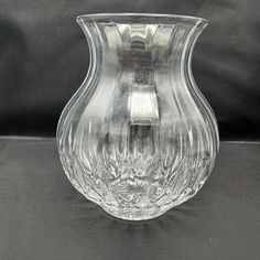 Bretagne pattern clear glass vase by Cristal D'Arques-Durand.  This amazing heavy lead crystal vase is 6.5 inches tall, 4 inches in diameter at the top, and the base measures 2 7/8 inches in diameter.  At its widest point it is approximately 5 inches in diameter.   This is a beautiful piece of  sparkling crystal, perfect for any occasion.  The top is slightly flared, and then it bursts out to a round lower part.  It is difficult to get a good picture because of the pattern cut into it of stripes from the top which then separate into a beveled pattern just below the widest part of the vase reflect the light so well. Please take a look at the video and you will see what I mean.   It is in excellent condition, no chips or scratches or staining.  It would be perfect as a Christmas, wedding, an 15th Anniversary Gift, Large Glass Vase, Vase Transparent, Clear Glass Vase, Grand Vase, Clear Vase, Clear Glass Vases, 15th Anniversary, Crystal Vase