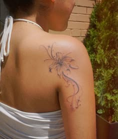 a woman with a flower tattoo on her back