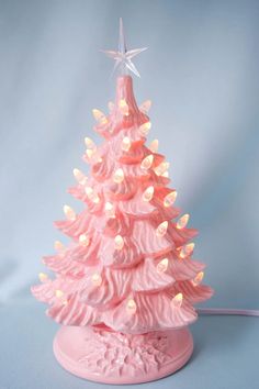 a pink ceramic christmas tree with white lights