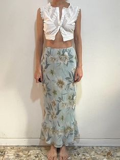 Beautiful 1990s silk bias cut maxi skirt.  So good with a simple white baby t or cropped tank top for a grunge feeling.  Sheer silk fabric.  Cut on the bias for a slinky silhouette.  Pale blue with a beige and cream floral pattern.  Beige lace trim towards the hem. Pale blue under slip.  Elastic band at the waist.  Label Allison Taylor, Size M, Outside material is silk, the lining is poly.  Please dry clean only.  Very good vintage condition with no fabric or sewing flaws.  Measurements - elastic Waist 74cm/ 29inches  Hips 100cm/ 39inches Waist to hem 100cm/ 39inches Models Measurements Shoulders 42cm/ 16.5inches Chest 84cm/ 33inches Waist 66cm/ 26inches Hips 92cm/ 36inches Height 175cm/ 5'9'' Simple T Shirt, Floral Maxi Skirt, Womens Skirts, Floral Maxi, Cropped Tank Top, Crop Tank, Pale Blue, Silk Fabric, Elastic Band