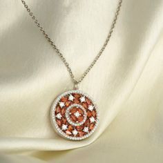 Like a bright sun on a winter morning, the Phoebe pendant elegantly juxtaposes the vivid hue of the orange sapphire with the white of brilliant-cut diamonds. Encircled by a ring of of pavé-set diamonds, this gorgeous pendant necklace is bound to add a little extra of ‘sunny’ to your day! Cubic Zirconia Medallion Necklace Gift, Diamond White Gemstone Round Necklace, Luxury Red Diamond Round Necklace, Diamond Necklace With Round Shape, Luxury Red Diamond Necklace, Luxury Red Round Diamond Necklace, Luxury Brilliant Cut Medallion Jewelry, White Gold Cubic Zirconia Medallion Jewelry, Sterling Silver Diamond Necklace With Gemstone