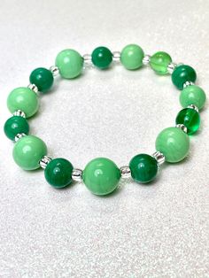 "Venetian Glass stretch bracelet in shades of green.  Alternating beads features shades of e-mails and opaque spring green. Each bead is handmade. Alternating shades of emerald and opaque light green add to this bracelet's interest This beautiful, handmade bracelet is suitable for all occasions and perfect size for most wrists. Measures 7.25\" Arrives in gift box, ready for gifting. Great for any occasion and nature-lovers, St Patrick's Day, love, friendship, mothers, daughters, birthday." Trendy Green Hypoallergenic Beaded Bracelets, Hypoallergenic Green Stretch Bracelet Gift, Green Round Beads Bracelet As Gift, Elegant Green Stretch Bracelet Gift, Trendy Green Stretch Bracelet Suitable As Gift, Trendy Green Beaded Bracelets, Trendy Green Round Beaded Bracelets, Hypoallergenic Green Bracelets As Gift, Trendy Green Beaded Bracelets As Gift