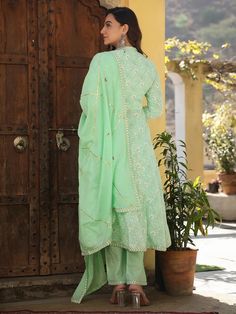 This is a beautiful 3-piece set. The set comes with printed & embroidered anarkali style kurta has mandarin collar, calf length & 3/4th sleeves teamed with trouser solid pants and an organza dupatta with border & gota detailing. Total No of Set-3 Suit Fabric : Cotton Dupatta Fabric-Organza Work Done on Kurta- Print & embroidery detailing Kurta Length-Calf Length Sleeve Length : 3/4th Sleeves Neck : V Neck Style : Anarkali Color : Green & Beige Occasion : Party Wear Washing Instructions: Hand Was