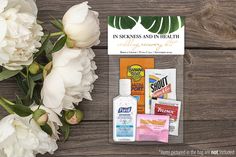 flowers and personal care products displayed on wooden table with business card in the middle, surrounded by white peonies