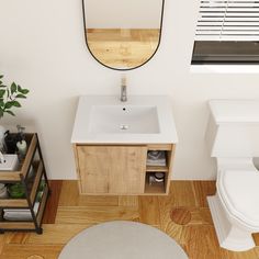 a white toilet sitting next to a bathroom sink under a mirror on top of a wooden cabinet