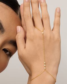 Break away from basic bracelets and amp up your look with this hand chain from wrist to finger. The subtly sweet and dainty chain meets premium AAAAA Cubic Zirconia stones for simple sophistication in your everyday outfits. Measurements: 14K yellow gold plated and rhodium plated. The ring portion measures 2.75 inches, the middle chain is 4.7 inches, and the bracelet is 5 inches with a 2.5-inch extender. 2.5mm premium AAAAA Cubic Zirconia. Simple Bracelets Gold, Basic Bracelets, Chain Body Jewelry, Basic Bracelet, High Support Bra, Hand Chain Bracelet, Bracelet And Ring, Cubic Zirconia Bracelet, Ring Chain