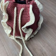 a crocheted bag sitting on top of a wooden floor