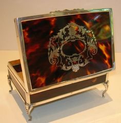 an ornate metal box sitting on top of a table