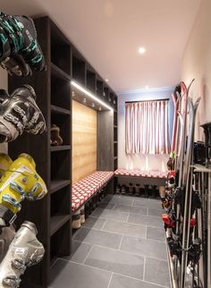 a room with skis and snowboards on the shelves, along with other sports equipment