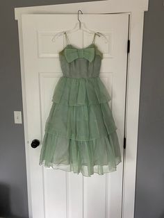 "1950's light green tiered ruffle party dress with big bow and spaghetti straps. Not in perfect condition - has several stains, one on the skirt and both underarms. Both underarms are also extremely ripped. Could use a long soak! See all photos, being sold as is Women's XXS 31\" bust 23\" waist free hips 40.5\" shoulder to hem (strap to bottom of last tier)" Red Velvet Shirt, Dress With Big Bow, Prom Dress Green, 1950s Prom, 1950s Prom Dress, Fair Outfits, Most Beautiful Dresses, Green Prom Dress, Big Bow