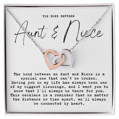 an open heart necklace with the words, aunt and niece on it in a gift box