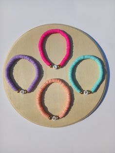 A heishi bead stretch bracelet in a choice of 4 beautiful, bright summer colours. The perfect gift for mum, a sister, friend or teacher! Each bracelet is personalised with the initial(s) of your choice. Our bracelets are high quality and made to last, but are made from a delicate material. We recommend not to wear them in the shower or while swimming. Trendy Stretch Bracelet With Letter And Heishi Beads, Pink Heishi Beads Stretch Bracelet, Everyday Pink Heishi Beads Stretch Bracelet, Bracelets Clay, Bead Stretch Bracelets, Clay Bead Bracelets, Order Letter, Heishi Bracelets, Summer Colours