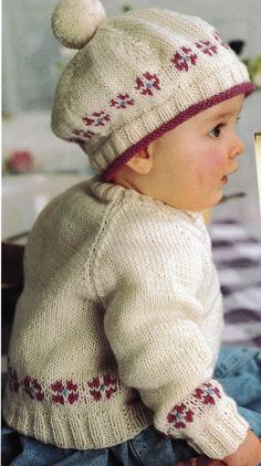 a baby wearing a knitted hat and sweater