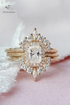 an engagement ring with a square diamond surrounded by smaller round diamonds