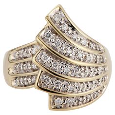 Vintage 1980's spray design diamond cocktail ring. 42 round brilliant cut diamonds set in a 14k yellow gold setting. Rhodium plating around the diamonds. 42 round brilliant cut diamonds, G-H SI approx. .25cts Size 8.75 and sizable 14k yellow gold Stamped: 14k 9.7 grams Width at top: 22.3mm Height at top: 6.2mm Width at bottom: 3.0mm Gold Spray, Diamond Cocktail Ring, Diamond Cocktail Rings, Yellow Gold Setting, Round Brilliant Cut Diamond, Cocktail Ring, Round Brilliant Cut, Brilliant Cut Diamond, Cocktail Rings