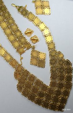 "Fabulous Etruscan Style gold plated filigree panel jewelry set/ parure: necklace, bracelet, clip on earrings and pierced earrings. The bracelet is 7 1/4\"\" long and 1 1/4\" wide and it has a flip over clasp. It has a 2\" long secure chain with the spring clasp The necklace , clip on earrings and the bracelet are marked \" D'Orlan\". The regular earrings are not marked. The inside necklace measurement is 17 inches and 5/8\" wide at the widest point.The middle ornamental piece is 6\" long and 3\ Formal Gold Plated Filigree Jewelry Sets, Festive Filigree Metal Jewelry, Festive Metal Filigree Jewelry, Gold Costume Jewelry Sets For Evening, Ornate Gold-tone Metal Jewelry, Elegant Gold-tone Jewelry With Filigree, Elegant Gold-tone Filigree Jewelry, Ornate Gold Metal Jewelry, Gold Jewelry Sets For Evening