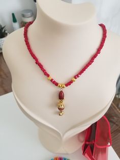 This historic and authentic sparkle red crystal necklace is the perfect gift for Valentine's Day, birthdays, or any special occasion. The necklace features a beautiful red crystal and a tiny golden heart charm, adding a touch of elegance and romance to any outfit. The necklace also features golden beads for added sparkle. Weighing in at only 20 grams, it is lightweight and easy to wear, making it perfect for everyday wear. It's also 44-48 cm (adjustable) in length. Give this necklace as a gift to a loved one and show them how much you care. It is also a great gift for any woman who loves sparkle and elegance in her jewelry. Surprise your loved one and make them feel special! Thank you so much for visiting and hope you enjoy shopping with us! ♥ Odinyo Family Spiritual Red Necklace With Heart Beads, Red Spiritual Necklace With Heart Beads, Red Carnelian Necklace For Valentine's Day, Red Heart-shaped Beaded Necklace Gift, Red Heart-shaped Beaded Necklace For Valentine's Day, Red Crystal Necklace, Golden Heart, Love Sparkle, Tiny Heart