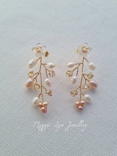 Truly beautiful bridal earrings, with a drop of approximately 4.5cm. Handmade with hand carved Mother of pearl flowers, quality natural ivory and blush pink freshwater pearls with the finest quality champagne crystals set on a Gilt gold plated, copper wire showing intricate detailing. All of our items are made to order so adjustments can be made with regards to materials and designs. Please message us if you require different specifications.  The design is handmade featuring natural freshwater p Delicate Pearl Drop Dangle Earrings, Handmade Delicate Pearl Earrings, Teardrop Clip-on Earrings For Wedding, Delicate Bridal Pearl Drop Earrings, Gold Flower Cluster Earrings For Wedding, Delicate Teardrop Flower Earrings For Weddings, Wedding Teardrop Clip-on Earrings, Dainty Pearl Earrings For Pierced Ears, Elegant Wedding Cluster Earrings With Ear Wire