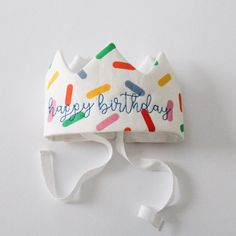 A little bit of magic for your birthday celebrations! Handcrafted from Oeko-Tex Certified Linen with a layer of batting for stability, the Happy Birthday Linen Crown is the cherry on top of a special day; sprinkles already included! 😉 FEATURES One size fits most This Linen Play Crown is embroidered with ‘happy birthday’ in blue thread. 100% pure European and Oeko-Tex Certified linen and finished with a twill tie Made in the USA from imported textiles CPSC Compliant Investing in the Happy Birthd Cute Multicolor Birthday Party Supplies, Fun White Birthday Party Supplies, White Fun Party Supplies For Birthday, Fun White Party Supplies For Birthday, Playful White Party Supplies For First Birthday, Playful Multicolor Birthday Party Supplies, Whimsical White Birthday Party Supplies, Whimsical White Party Supplies For Birthday, Waldorf Crown