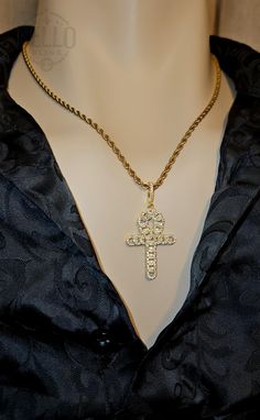 Embrace the symbolism of eternal life with our Egyptian Ankh Cross Pendant Necklace. This stunning pendant features the Ankh cross, beautifully adorned with sparkling stones, representing life and spirituality. Pendant Material: 925 Sterling Silver- Gold Finish Chain Material: Stainless Steel - Gold Finish Design: Egyptian Ankh cross with sparkling stones Features: Hypoallergenic, suitable for sensitive skin Perfect For: Daily wear, spiritual gatherings, special occasions, or as a thoughtful gif Spiritual Pendant Jewelry With Rope Chain, Spiritual Jewelry With Large Crucifix Pendant, Spiritual Crucifix Jewelry With Large Pendant, Spiritual Rope Chain Necklace, Symbolic Large Cross Pendant Jewelry, Symbolic Yellow Gold Cross Jewelry, Spiritual Yellow Gold Jewelry With Rope Chain, Spiritual Pendant Cross Necklace, Rope Chain Necklace With Cross Pendant For Gift