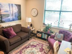 a living room filled with furniture and a large window