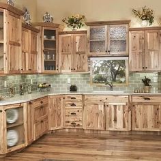 a kitchen with wooden cabinets and green tile backsplash