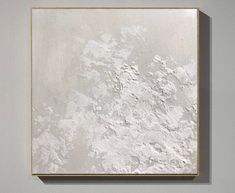 an abstract painting is shown on the wall in front of a white background with gold trim