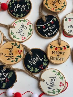 christmas ornaments are hanging from twine with string and wood slices that say merry bright