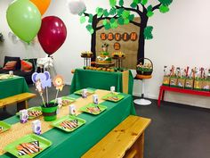 an animal themed birthday party with green table cloths