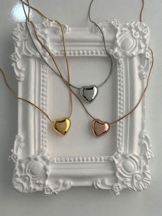 Add a touch of elegance with the beautiful Wendy necklace. Featuring a chubby metallic heart charm sliding along a delicate snake chain, this necklace adds a playful yet chic touch to any outfit. Whether you're dressing up or keeping it casual, this necklace offers style and sophistication for every day. The snake chain design requires extra care to prevent kinks and damage. Additionally, the chubby heart charm is prone to scratches, so please handle with care to maintain its pristine look. Mate Valentine's Day Gift Snake Chain Necklace, Trendy Rose Gold Heart Necklace, Snake Chain Heart Necklace For Gifts, Trendy Delicate Snake Chain Necklace Gift, Minimalist Necklaces For Valentine's Day Party, Trendy Rose Gold Heart Charm Necklaces, Trendy Rose Gold Heart Charm Necklace, Trendy Adjustable Snake Chain Necklace For Gift, Trendy Adjustable Snake Chain Necklace As Gift