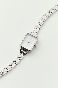 Classic metal rectangle watch. Essential watch style with a linked chain in polished metal complete with a rectangle style face. Features Classic metal rectangle face watch Linked banded watch Simple rectangle watch case Glass face Lined chain band In silver or gold tone metal Clasp closure Content + Care Mixed metal, glass Avoid contact with water Imported Size Strap length: 7.24" l Case: .98" x .78" | Classic Metal Rectangle Face Watch in Silver, Women's at Urban Outfitters Small Watches Women, Everyday Jewelry Silver, Rectangle Watch, Rectangle Face, Silver Watches Women, Small Watch, Minimalist Watch, Crystal Watches, Watches Luxury