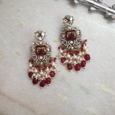 Ruby Red Drops Fine Kundan Chaandbali, Sabyasachi Jewelry, Moissanite, Indian Jewelry, Kundan Jewelry, Long AD Earrings, Bollywood Earrings Length: 3 inches Material: Stone, AD. Kundan Package: A pair of earrings High quality and craftsmanship, Designer jewelry. Free standard shipping If you have any questions or concerns please let me know. I'll be happy to answer them. Thank you so much for visiting our shop Luxury Red Kundan Chandbalis, Red Chandbali Chandelier Earrings For Celebrations, Fusion Kundan Chandelier Earrings For Reception, Temple Jewelry Red Chandbalis Drop Earrings, Kundan Chandelier Earrings For Reception, Silver Ruby Earrings For Festivals, Elegant Ruby Chandbalis For Celebration, Fusion Style Chandelier Earrings For Festivals And Celebrations, Fusion Style Bridal Earrings With Latkans For Festive