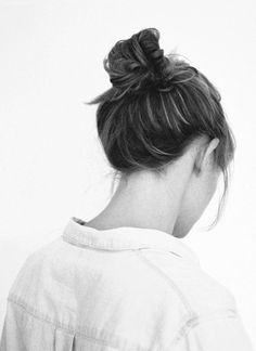 black and white photograph of a woman with her back to the camera, looking down