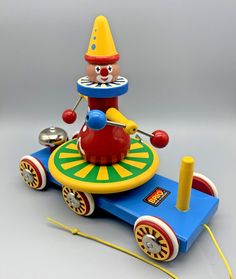 This Vintage BRIO Clown Go Round Carousel Wooden Pull Toy is a rare find for any collector. Made in Sweden, this toy has been well taken care of and is in overall great condition. The multicolor design is perfect for any unisex child aged 1-2 years old. The BRIO brand is known for their quality toys, and this clown go round carousel pull toy is no exception. It's a perfect addition to any preschool toy collection and provides endless fun for little ones. Sold as is, this vintage toy is a must-have for any BRIO enthusiast. Item does not come with stacker rings item is sold as shown. Toys From The 60's And 70's, Vintage Toys 1960s, Stacker Rings, Pull Toy, Preschool Toys, Digital Backdrops, Antique Toys, Old Toys, Fisher Price