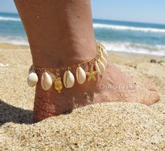 This beautiful beach dainty anklet or bracelet is made with cowrie shells, 24k gold plated brass pendants (seahourse, fish, starfish), 24k gold plated chain and 18k gold plated lobster clasp. An 1.5-inch extension chain is added to each bracelet. Your anklet or bracelet comes gift wrapped and shipped via priority registered air mail with tracking info available. Feel free to ask me any questions! Thanks for visiting and happy shopping :) Gold Shell Bracelet For Vacation, Adjustable Gold Anklets For Beach Season, Gold Starfish Shell For Beach, Shell Strand Anklets As Gift, Gold Shell With Starfish Charm For Beach, Gold Shell Strand Bracelets, Gold Beachy Bracelets For Summer, Adjustable Gold Strand Anklets, Ocean-inspired Gold Bracelets For Beach Season