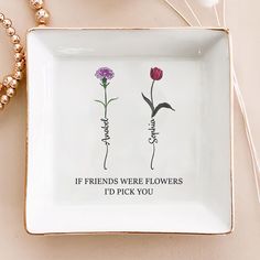 two flowers on a plate that says if friends were flowers i'd pick you