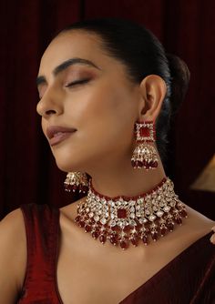 Make a striking statement with this Red Polki Choker set, featuring radiant red stones set in traditional Polki design and finished with a luxurious rose gold touch. The elegant choker design offers a contemporary twist on classic beauty, with the rose gold accents enhancing the deep red hues. Ideal for weddings, festive occasions, or any special event, this set brings together timeless sophistication and modern flair. Festive Red Ruby Jewelry Set, Luxury Red Jewelry For Festive Occasion, Luxury Red Festive Jewelry, Rose Gold Ruby Jewelry For Parties, Luxury Red Jewelry Sets For Wedding, Luxury Red Bridal Necklace For Celebration, Red Hand Set Kundan Necklace For Party, Red Jewelry Sets For Formal Festivals, Elegant Red Jewelry Sets For Festive Occasions