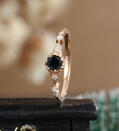 a black diamond ring sitting on top of a wooden table