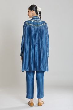 Blue kurta featuring mirror and sequin embroidery with a collared neckline and long cuffed sleeves. Paired with matching pants made from pure chanderi silk., Fit: Relaxed Bollywood Style Indigo Festive Set, Festive Blue Pants With Chikankari Embroidery, Festive Blue Pant Set, Indigo Traditional Drape Set For Diwali, Blue Pants For Festive Eid Celebration, Festive Blue Pants For Eid, Bollywood Style Indigo Sets With Pallu, Indigo Bollywood Sets With Pallu, Bollywood Indigo Sets With Pallu