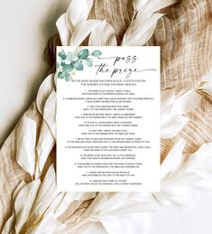 what did the groom say card on top of some white flowers and feathers with green leaves