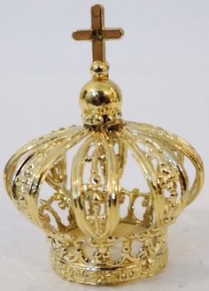 a gold crown with a cross on top is shown in front of a white background