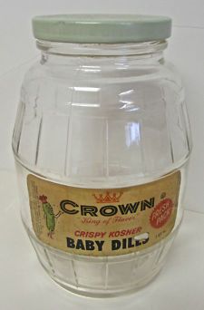 a baby dill jar sitting on top of a white table